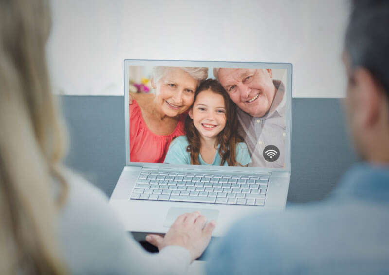 Couple having video chat on laptop Girls Who Travel | 10 Ways to Stay Connected While Apart