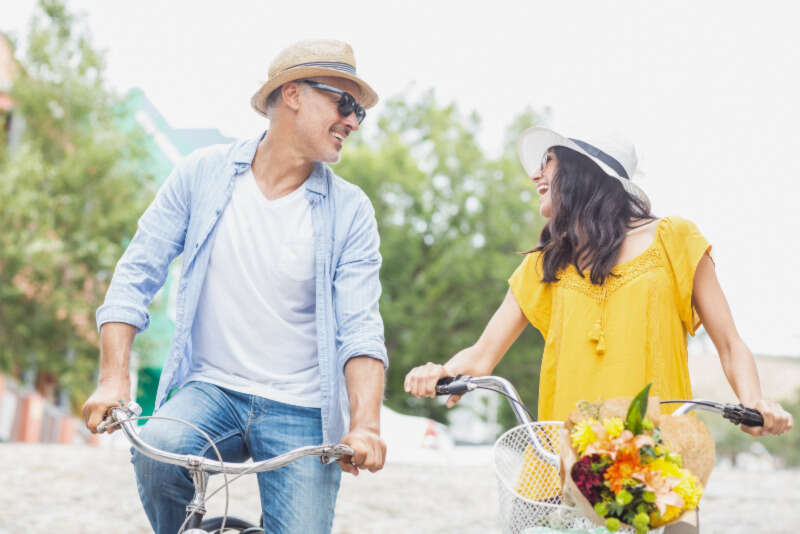 Happy couple with bicycles Girls Who Travel | 7 Tips For Not Killing Your Partner In Quarantine