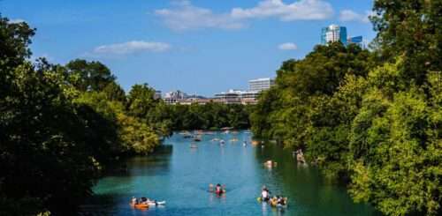 Austin, TX, isn’t just the capital of live music and barbecues. It’s also a haven for outdoor enthusiasts and nature lovers, offering a vibrant scene that perfectly blends urban charm with natural beauty.  Austin provides a unique destination for travelers looking for their next adventure with activities to recharge, challenge, and inspire. Whether solo or with your squad, there are plenty of ways to enjoy the great outdoors of Austin, TX! Relish Austin’s Natural Beauty With These Outdoor Activities Hiking the Greenbelt  The Barton Creek Greenbelt boasts over 12 miles of lush trails, hidden swimming holes, and towering cliffs perfect for an adventurous trek. Before heading out, make sure to pack plenty of water, a map of the trails, and your best hiking boots. The Greenbelt has everything you need, whether you’re looking for a challenging hike or a serene walk in nature. Kayaking or Paddleboarding on Lady Bird Lake  For a more laid-back but equally rewarding experience, stand-up paddleboarding (SUP) and kayaking on Lady Bird Lake offers a unique vantage point of Austin’s skyline coupled with a good full-body workout.  Early mornings are magical as the city stirs to life, and the water remains blissfully calm—perfect for beginners. Remember to wear a life jacket and slather on sunscreen for a safe and enjoyable outing. Exploring Zilker Park  One way to enjoy the great outdoors of Austin without venturing too far off the beaten path is by exploring Zilker Park. Zilker Metropolitan Park is Austin’s recreational hub, a sprawling 350-acre green space that invites you to lay down a blanket and enjoy a picnic, rent a paddle boat, or join a volleyball game.  It’s the perfect spot to unwind after a day of adventures, as it has plenty of scenic spots for meditation or yoga stretches. Check out the botanical garden or dip in Barton Springs Pool, an iconic Austin spring-fed swimming hole. Yoga at Sunrise  The serene beauty of Austin provides the perfect backdrop for an early morning yoga session. Austin has numerous spots where you can unroll your mat and greet the day. Local studios often host outdoor classes, allowing you to meet fellow yogis. Fishing the Austin Lakes  For those who find tranquility in fishing, Austin’s surrounding lakes—Lake Travis, Lake Austin, and Lady Bird Lake—offer plentiful spots teeming with bass, catfish, and sunfish. A morning spent by the lake, with the rod in hand and the gentle water lapping at your feet, can be incredibly peaceful.  Even if you don’t consider yourself much of an angler, consider taking a guided tour. One of the great benefits of taking a guided fishing tour is fishing with an experienced local angler who will ensure you don’t go home empty-handed!  Austin extends beyond its reputation as a cultural hotspot, inviting adventurers to explore its abundant outdoor activities. The city offers a diverse playground for those seeking adventure and rejuvenation in the great outdoors. Gather a sense of adventure and experience the unique blend that Austin offers!
