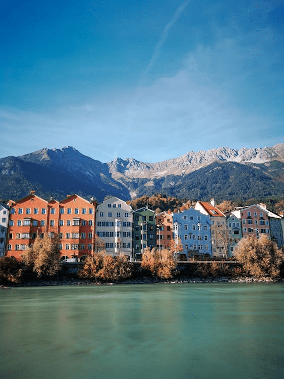 Colorful buildings in Innsbruck with snowy Alps in the background